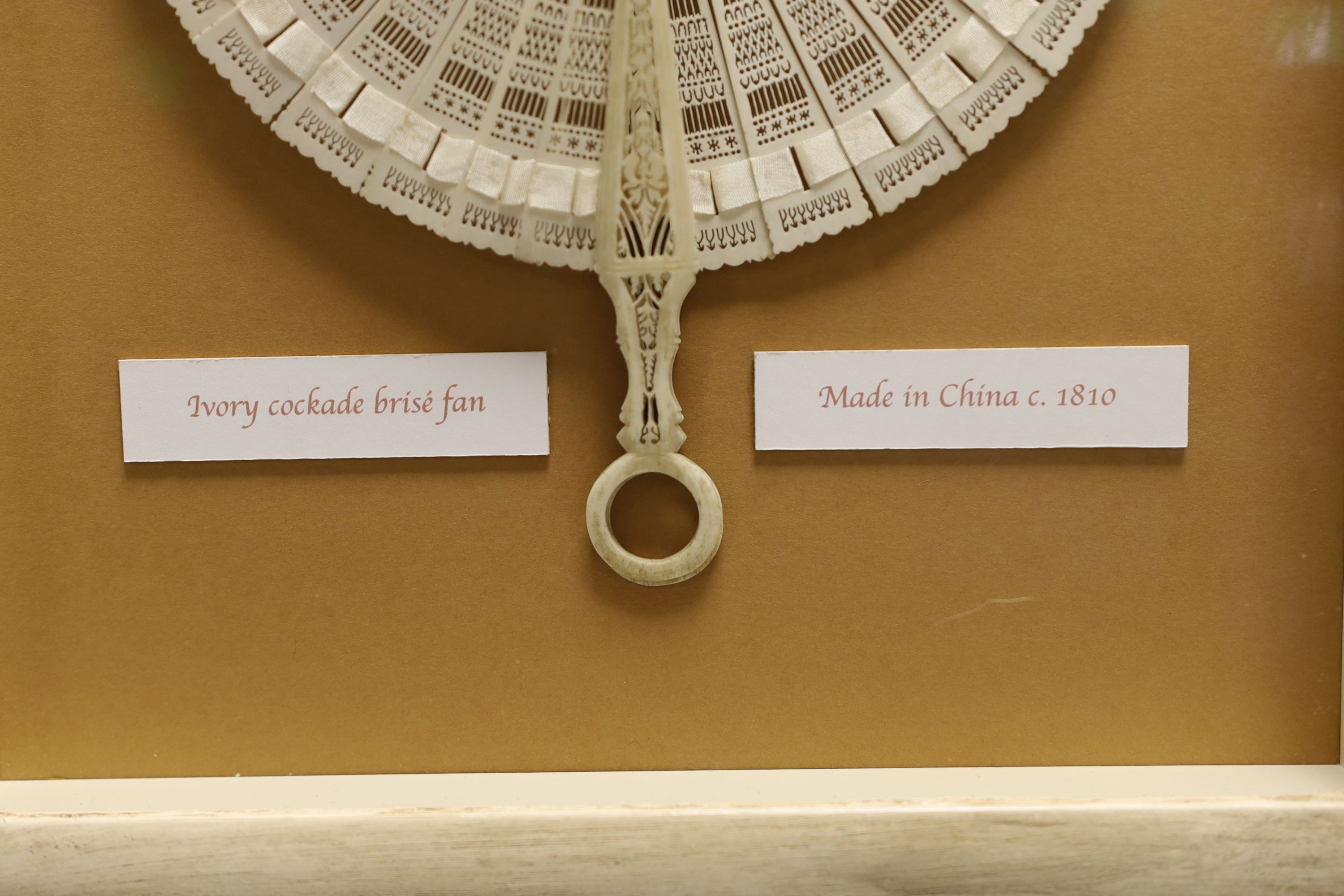 A 19th century ivory cased cockade brisé fan, bearing inscription to verso